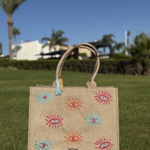 A modern twist on the classic evil eye blending baby blue, orange, and fuchsia.