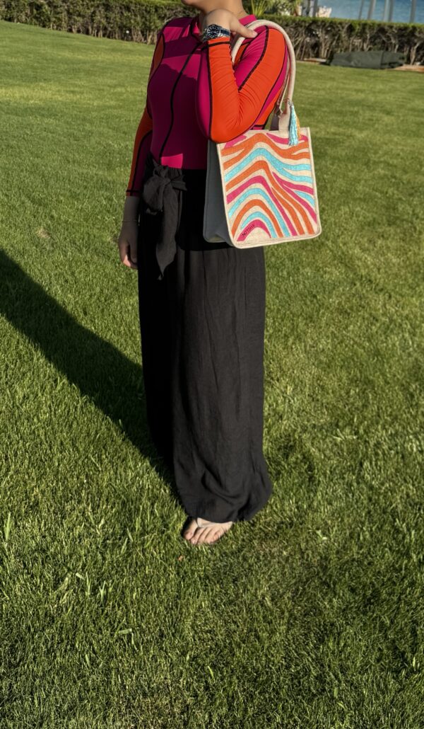 A modern twist on the classic evil eye blending baby blue, orange, and fuchsia. - Image 4
